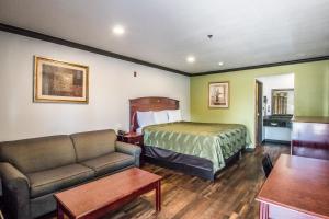 a hotel room with a bed and a couch at Americas Best Value Inn Fort Worth in Fort Worth +35 photos