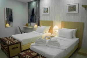 Ένα ή περισσότερα κρεβάτια σε δωμάτιο στο LightHouse Hotel & ShortStay @ Damansara Uptown
