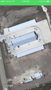 an overhead view of a large metal building with cars at Sagebrush Hotel in Crystal City +1 photo