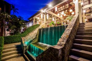 a staircase leading to a house with a waterfall at Baan Haad Ngam Boutique Resort in Chaweng
