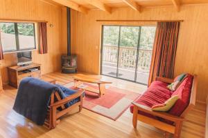 ein Wohnzimmer mit einem Sofa und einem Kamin in der Unterkunft Tangiaro Retreat in Colville