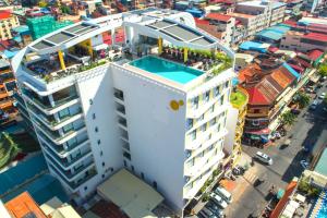 an overhead view of a white building with a swimming pool at SUN & MOON, Urban Hotel in Phnom Penh