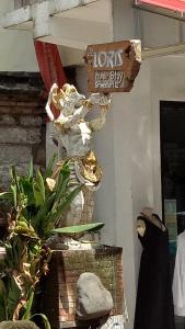 eine Statue eines Löwen auf der Seite eines Gebäudes in der Unterkunft Loris Homestay in Ubud