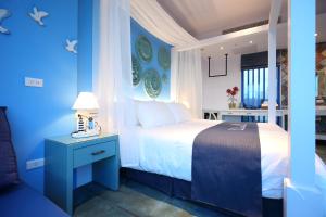 Postel nebo postele na pokoji v ubytování Hualien S.E.A. B&B