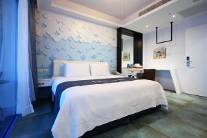 Postel nebo postele na pokoji v ubytování Hualien S.E.A. B&B