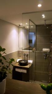 a bathroom with a sink and a shower at Hotel-Restaurant Lann Roz / Côte Cuisine in Carnac