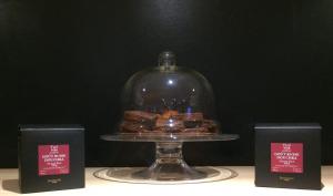 a glass dome with some pastries on a table at Hotel-Restaurant Lann Roz / Côte Cuisine in Carnac