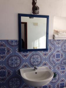 a bathroom with a sink and a mirror at La Lampara in Stromboli