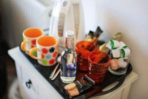a counter with cups and bottles on a table at Blue Sky Bed and Breakfast in St Ives