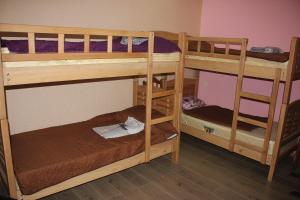 two bunk beds in a room with another bed at RiverSide Hostel Borjomi in Borjomi