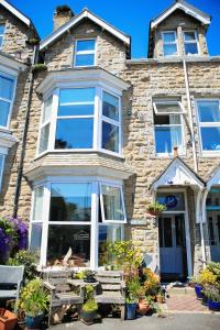 a stone house with a bench in front of it at Blue Sky Bed and Breakfast in St Ives