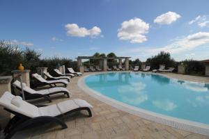 a swimming pool with lounge chairs and a gazebo at Il Gabellota Resort in Alberobello