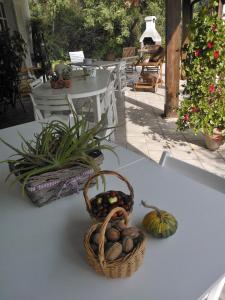 a basket of fruit on a table with a basket of nuts at B&B Villa Ada in Formia
