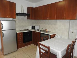 a kitchen with a refrigerator and a table with a white table cloth at One Bedroom aptm Larnaca in Larnaka