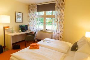 
Ein Bett oder Betten in einem Zimmer der Unterkunft Hotel Ostseeländer
