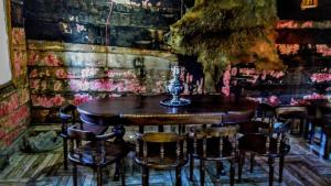 a wooden table and chairs in a room at Discover Kinchkha in Satsiskvilo