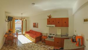 a kitchen and living room with a couch and a table at Angela Apartments in Kokkari