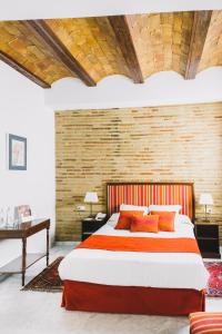 a bedroom with a large bed and a brick wall at Ad Hoc Monumental 1881 in Valencia