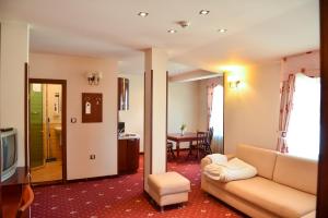 a living room with a couch and a table at Martin Club Hotel in Bansko