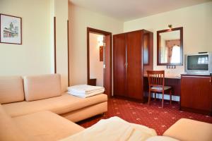 a living room with a couch and a television at Martin Club Hotel in Bansko