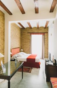 a hotel room with a bed and a desk at Ad Hoc Monumental 1881 in Valencia