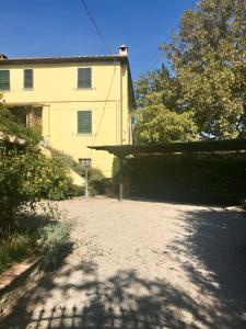 a house with a driveway in front of a building at Giardino Di Sara in Cortona