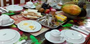 a table with a breakfast of eggs and cheese at Seasons Four Eco Friendly Treehouse in Matara