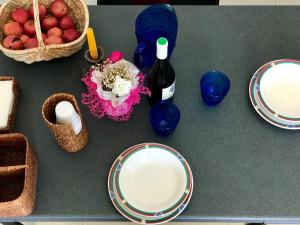 a table with plates and a bottle of wine at Da Paolo e Antonietta in Mazara del Vallo +13 photos