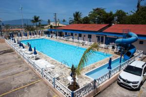 a pool at a hotel with a water slide at Hotel Litoral Norte in Caraguatatuba