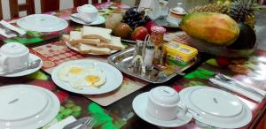 a table with a breakfast of eggs and cheese at Seasons Four Jungle Treehouse in Matara