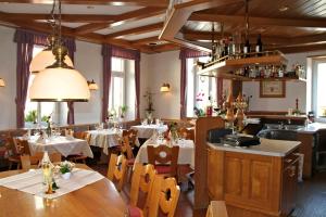 a restaurant with tables and chairs in a room at Hotel- Restaurant Zum Schwan in Waldfischbach-Burgalben