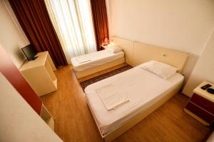 Ένα ή περισσότερα κρεβάτια σε δωμάτιο στο Hotel Argenti