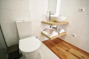 a bathroom with a white toilet and a sink at Invictus Place in Porto +19 photos