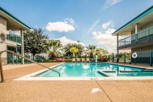 a swimming pool in front of a building at Americas Best Value Inn Fort Worth in Fort Worth