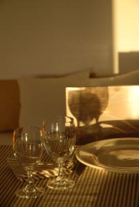 two wine glasses and a plate on a table at Dar Al Manar in El Jadida