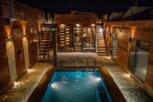a pool in the middle of a house at night at Hotel Manada del Desierto in San Pedro de Atacama