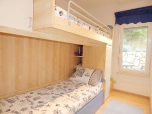 a small bedroom with a bunk bed and a window at Lavander Apartments Omiš in Duće +27 photos