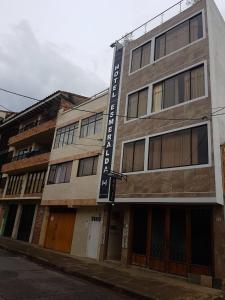 a building with a sign on the side of it at Hotel Esmeralda in San Gil
