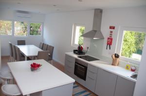 a kitchen with white counters and a white counter top at Pine Tree Villa in Cascais