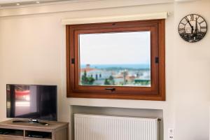 A television and/or entertainment centre at Leo - Unique Glyfada Apartment