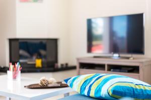 A television and/or entertainment centre at Leo - Unique Glyfada Apartment