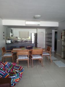 a dining room with a table and chairs and a kitchen at Tribal Concept in Cape Town +11 photos