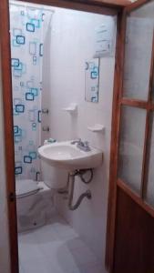 a bathroom with a sink and a toilet at Real Bonanza Posada in Guanajuato