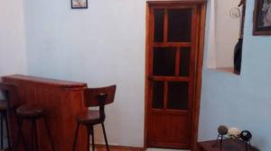 a room with a desk and a wooden book shelf at Real Bonanza Posada in Guanajuato