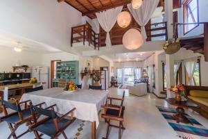 a kitchen and living room with a table and chairs at Residence Pé na Areia in Arraial d'Ajuda