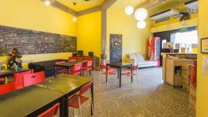 a restaurant with tables and chairs in a room at The Hive Singapore Hostel in Singapore