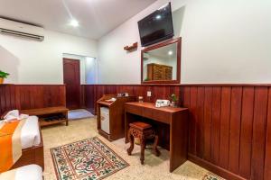 a bedroom with a desk and a mirror at BayStone Resort in Siem Reap