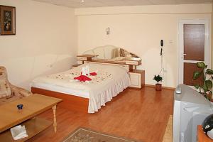 a bedroom with a bed with a red star on it at Hotel Rade 2 in Vratsa