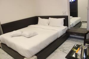 Een bed of bedden in een kamer bij Hotel Delight