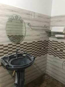 a bathroom with a sink and a mirror at Munroe Heritage Inn in Munroe Island